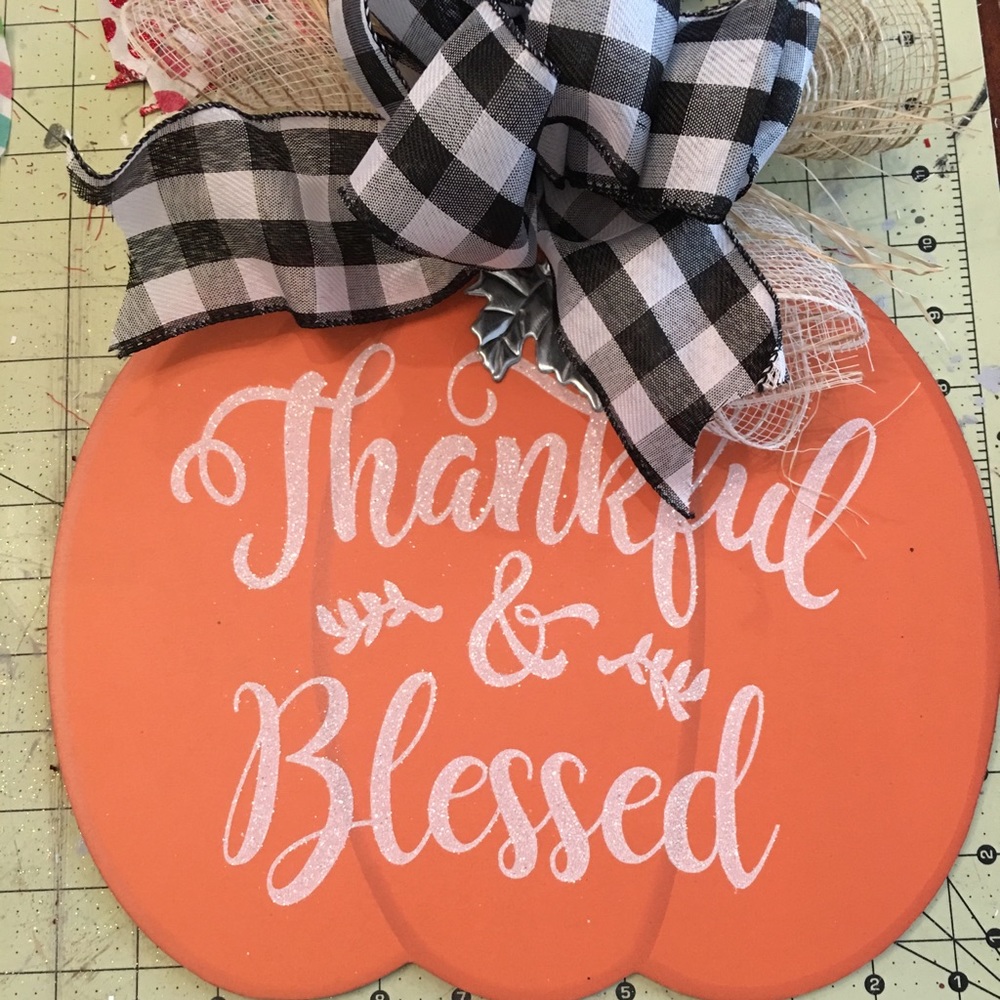 A cute fall pumpkin with a buffalo ribbon.